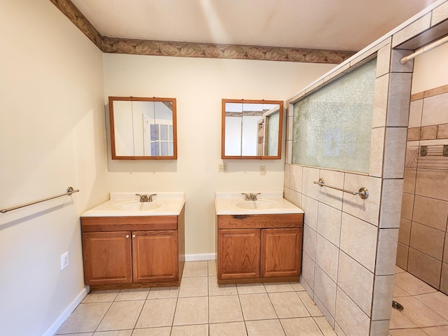 bathroom featuring tiled shower, two vanities, and tile patterned flooring