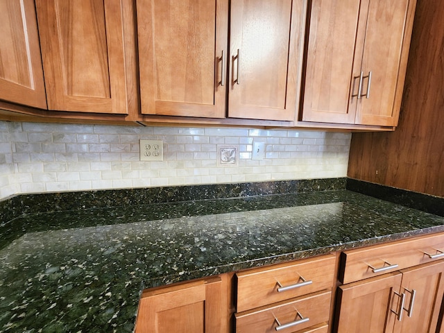 kitchen with decorative backsplash and dark stone countertops