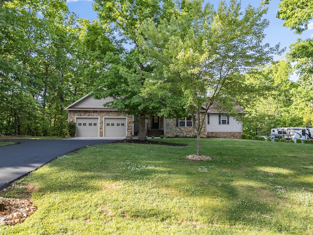 obstructed view of property featuring an attached garage, asphalt driveway, a front yard, and stone siding