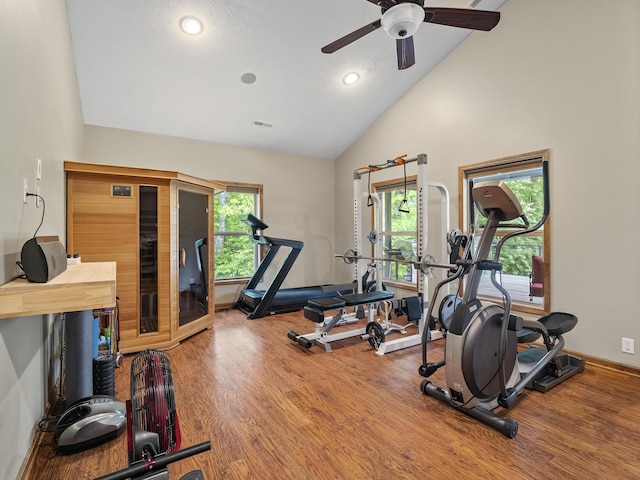 workout room featuring wood finished floors, ceiling fan, baseboards, high vaulted ceiling, and recessed lighting