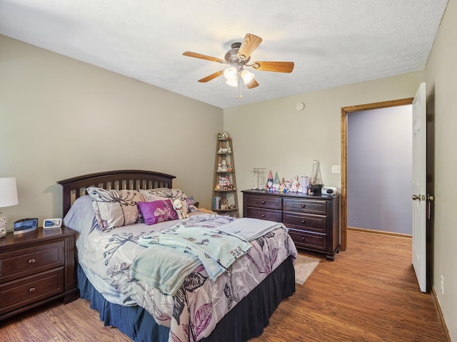 bedroom featuring light wood-style floors and a ceiling fan