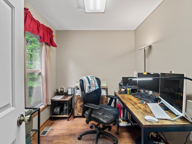 home office with wood finished floors and baseboards