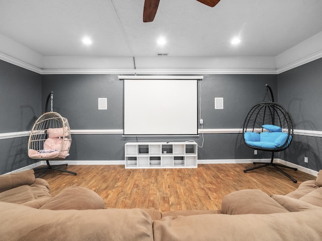 cinema room featuring wood finished floors, a ceiling fan, baseboards, and recessed lighting