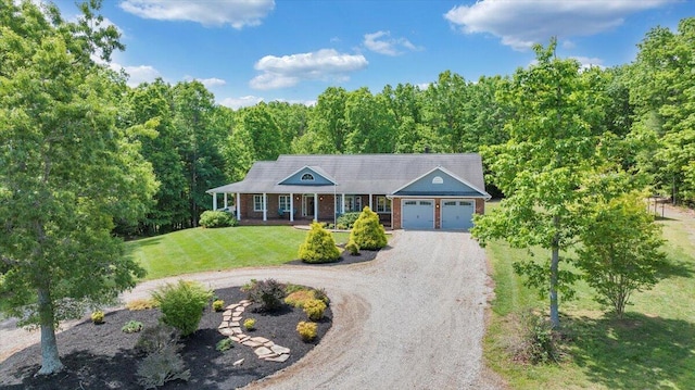 23 Alean Rd, Rocky Mount, VA 24151 - view of front of house with an attached garage, dirt driveway, a front yard, a forest view, and covered porch