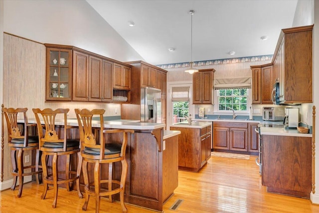 23 Alean Rd, Rocky Mount, VA 24151 - kitchen with stainless steel appliances, a sink, a breakfast bar, light countertops, and vaulted ceiling
