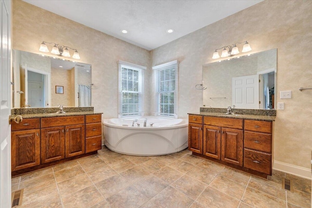 23 Alean Rd, Rocky Mount, VA 24151 - bathroom featuring two vanities, a garden tub, and baseboards