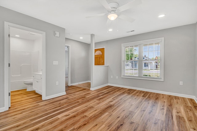 unfurnished bedroom featuring light wood finished floors, baseboards, recessed lighting, connected bathroom, and ceiling fan