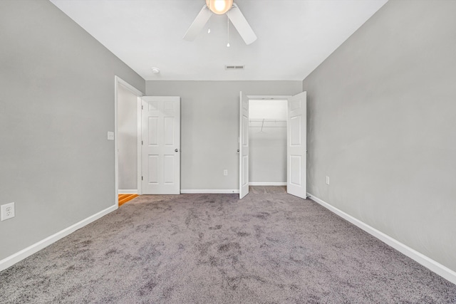 unfurnished bedroom featuring carpet, baseboards, a ceiling fan, and a closet