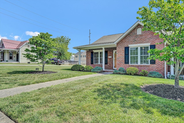 view of front of property with brick siding and a front yard