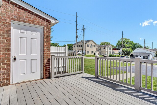 wooden terrace with a yard and a residential view