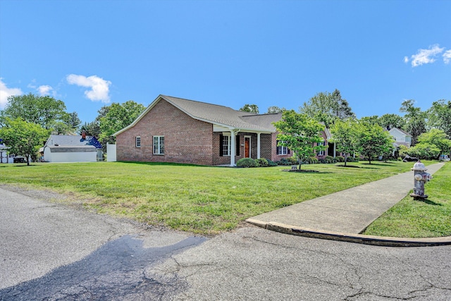 view of side of property featuring brick siding and a lawn