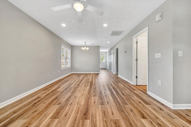 unfurnished room with a chandelier, light wood-type flooring, baseboards, recessed lighting, and ceiling fan