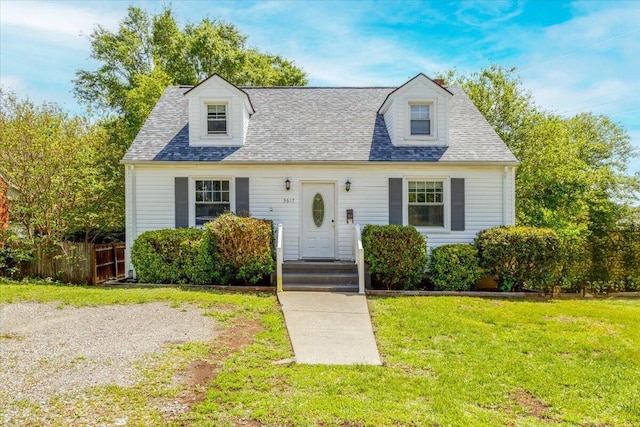 new england style home featuring a shingled roof
