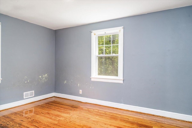empty room featuring wood finished floors and baseboards