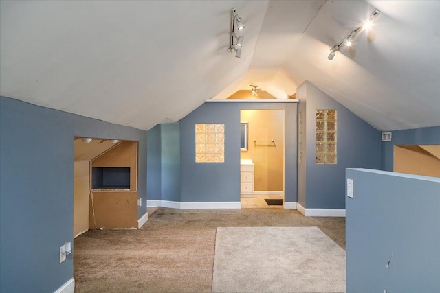 bonus room featuring carpet flooring, vaulted ceiling, and baseboards