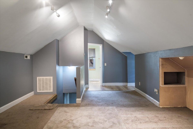 additional living space with carpet floors, vaulted ceiling, and baseboards