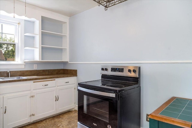 kitchen with range with electric cooktop, a sink, open shelves, dark countertops, and white cabinets