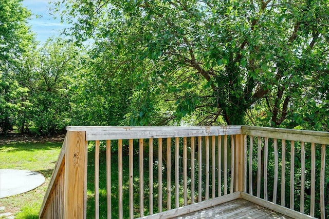 wooden terrace featuring a lawn