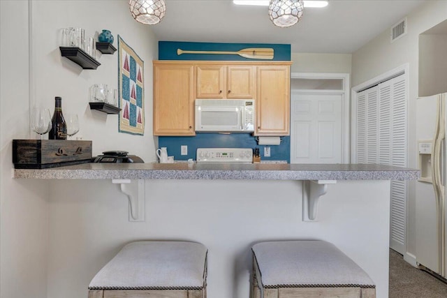 1217 Graves Harbor Trl Unit 119, Huddleston, VA 24104 - kitchen with white appliances, light brown cabinetry, a kitchen bar, and light countertops