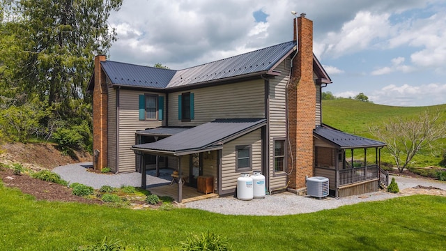 336 Turkey Run Ln, Rural Retreat, VA 24368 - back of house with a chimney, a yard, metal roof, and central AC