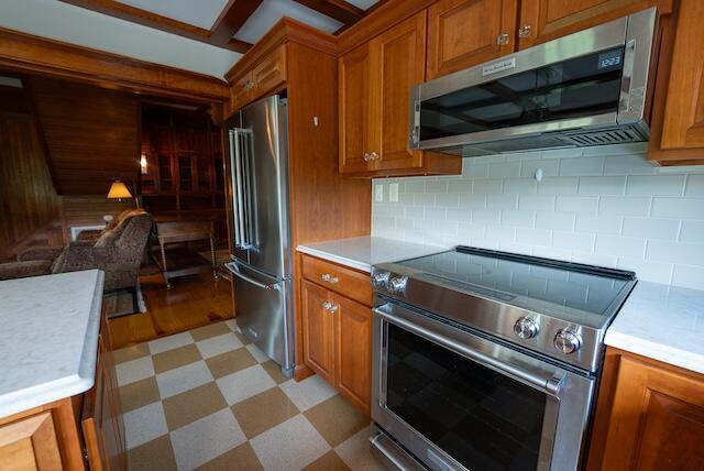 336 Turkey Run Ln, Rural Retreat, VA 24368 - kitchen with premium appliances, brown cabinetry, open floor plan, light countertops, and light floors
