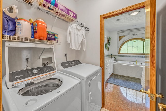 clothes washing area with washing machine and clothes dryer and marble finish floors