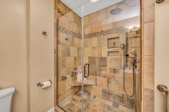 bathroom with toilet and a stall shower