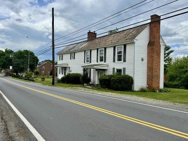 view of front of home featuring a chimney