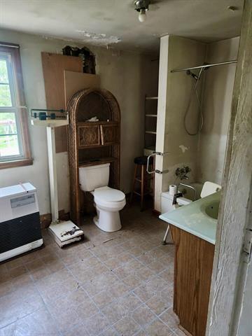 full bathroom with toilet, vanity, and tile patterned floors