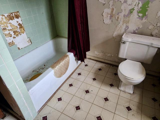 bathroom featuring toilet and tile patterned flooring