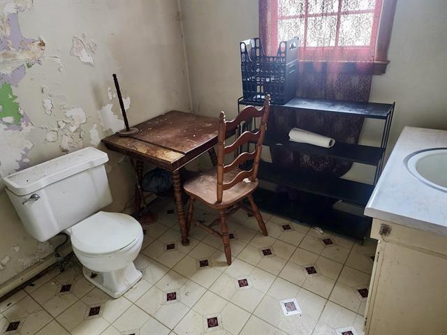bathroom featuring toilet, vanity, and tile patterned flooring