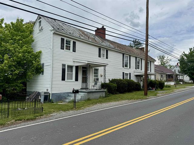 view of front of home featuring a chimney