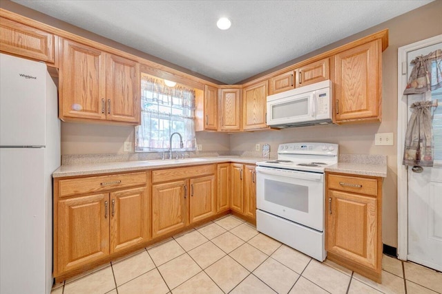 1921 Clinton Ave SE, Roanoke, VA 24013 - kitchen with white appliances, a sink, light countertops, light tile patterned flooring, and recessed lighting