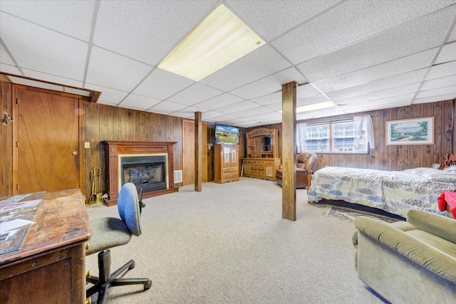 1921 Clinton Ave SE, Roanoke, VA 24013 - carpeted bedroom featuring wooden walls, a drop ceiling, and a fireplace
