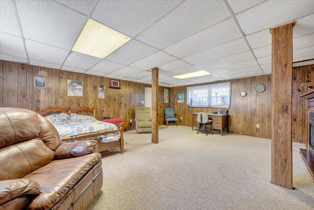 1921 Clinton Ave SE, Roanoke, VA 24013 - living room with carpet flooring, a paneled ceiling, wood walls, a desk, and a fireplace