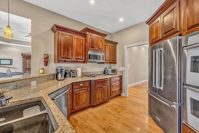 73 Windmere Trl, Moneta, VA 24121 - kitchen with appliances with stainless steel finishes, a sink, light wood-style flooring, light stone counters, and recessed lighting