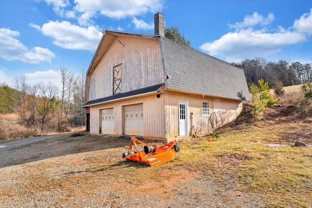 380 Trails End Dr, Hardy, VA 24101 - view of side of property featuring driveway, a gambrel roof, a chimney, a shingled roof, and a garage