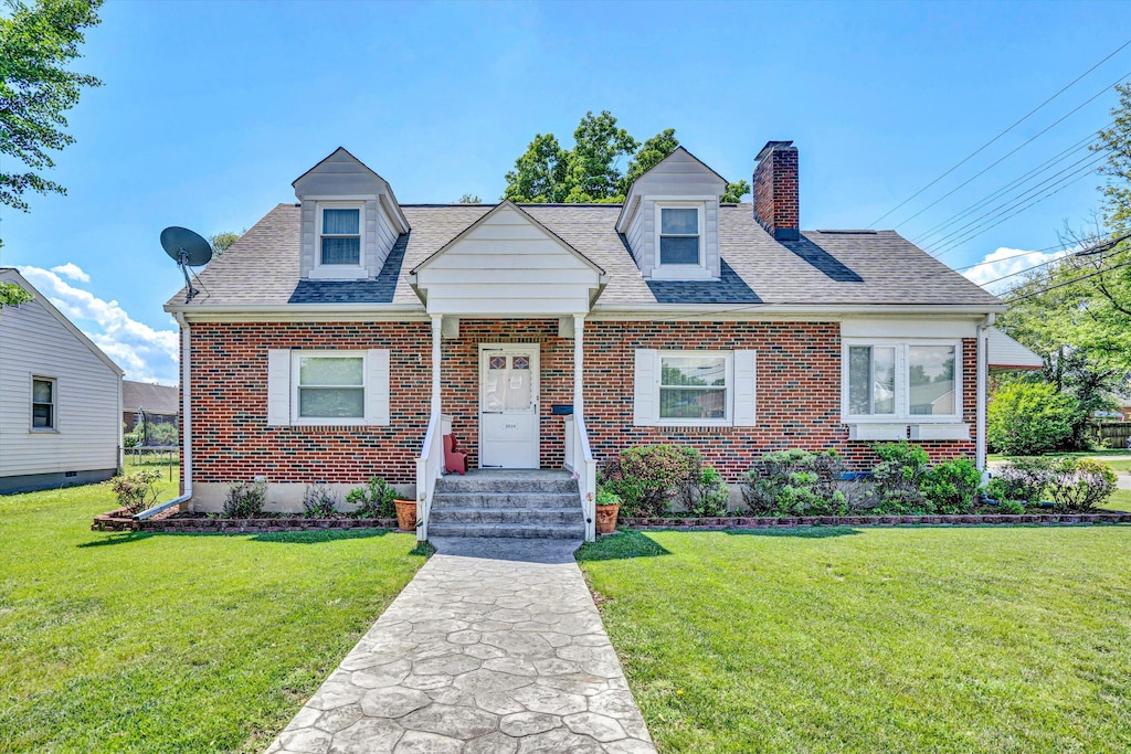 2920 Bradley St NE, Roanoke, VA 24012 - cape cod home with a chimney, brick siding, and a front yard