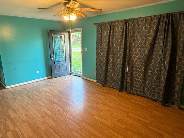 1433 Morehead Ave SE, Roanoke, VA 24013 - unfurnished room featuring a ceiling fan, wood finished floors, and baseboards