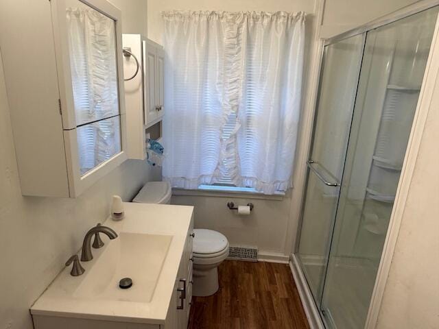 1433 Morehead Ave SE, Roanoke, VA 24013 - bathroom with toilet, wood finished floors, a stall shower, and vanity