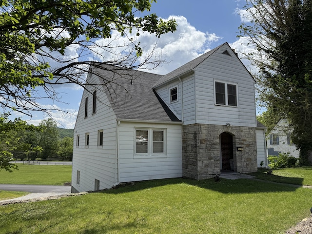 111 Rosedale Ave, Covington, VA 24426 - traditional-style house featuring a front lawn, a shingled roof, and stone siding