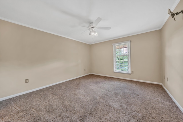 empty room with ceiling fan, ornamental molding, baseboards, and carpet