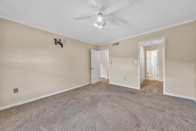 unfurnished bedroom with ornamental molding, carpet floors, baseboards, and a ceiling fan
