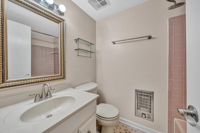full bathroom with toilet, heating unit, vanity, and a shower