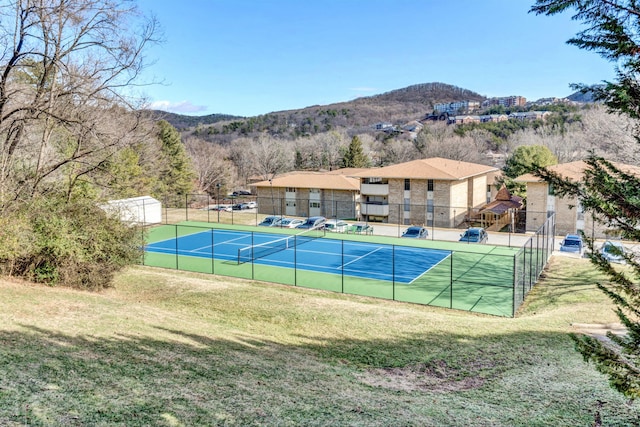 view of tennis court featuring a mountain view