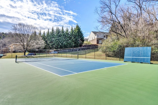 view of tennis court featuring fence