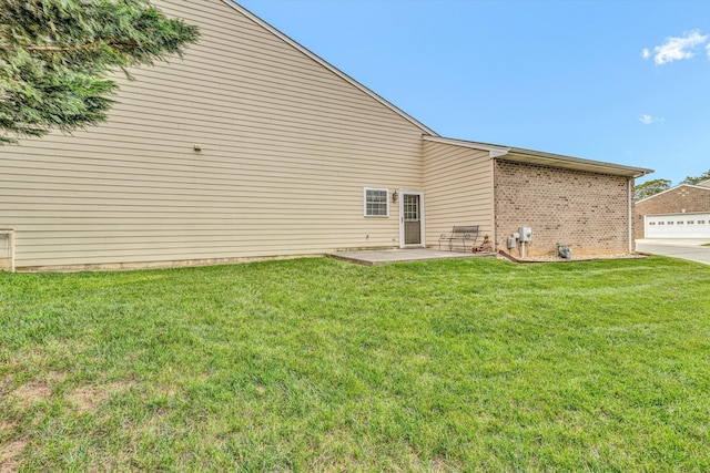 rear view of property with a patio and a lawn