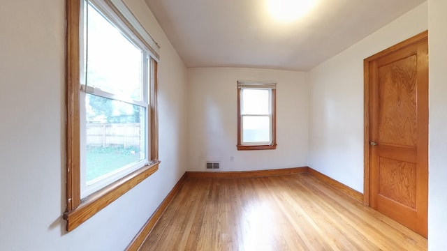 spare room featuring light wood-style flooring and baseboards