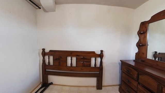bedroom featuring baseboards and tile patterned floors
