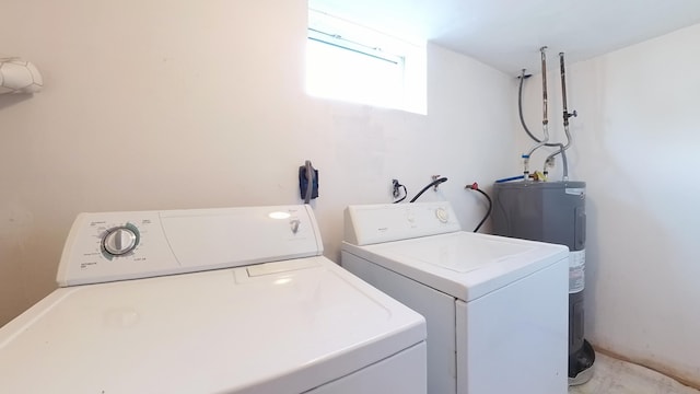 clothes washing area with washer and clothes dryer and electric water heater